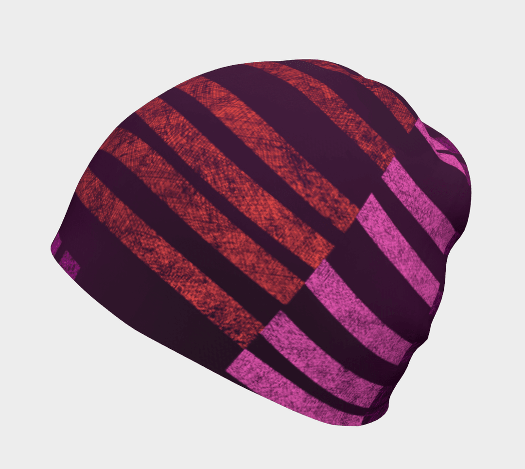Purple Waves beanie showing a gradient of red and pink stripes on a plum background, angled view.