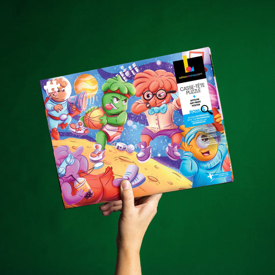 Hand holding the Cosmic Slam jigsaw puzzle box, showcasing its vibrant artwork and bilingual packaging.