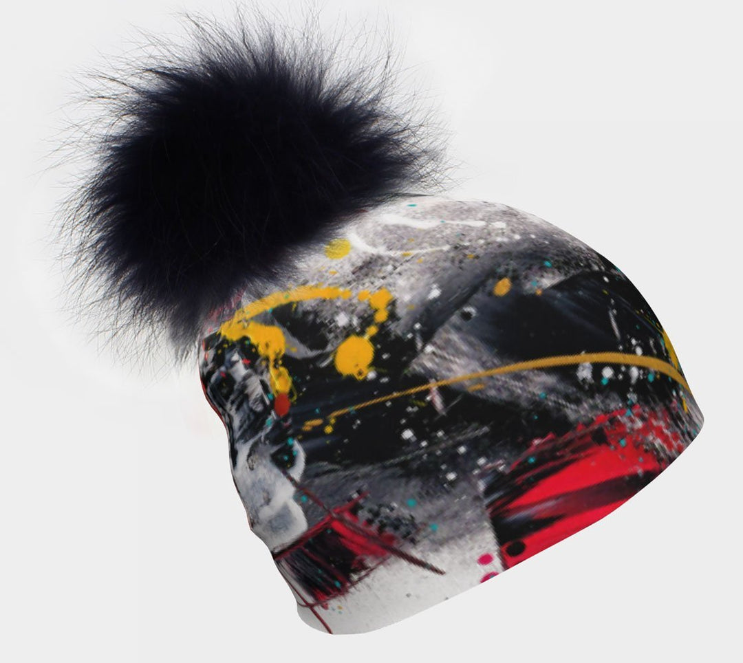Red and Black Removable Pompom Beanie with a large black fur pompom against a white background.