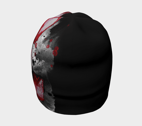 A profile view of the Red Rose Beanie, emphasizing the contrasting black fabric with scattered red paint splatters.
