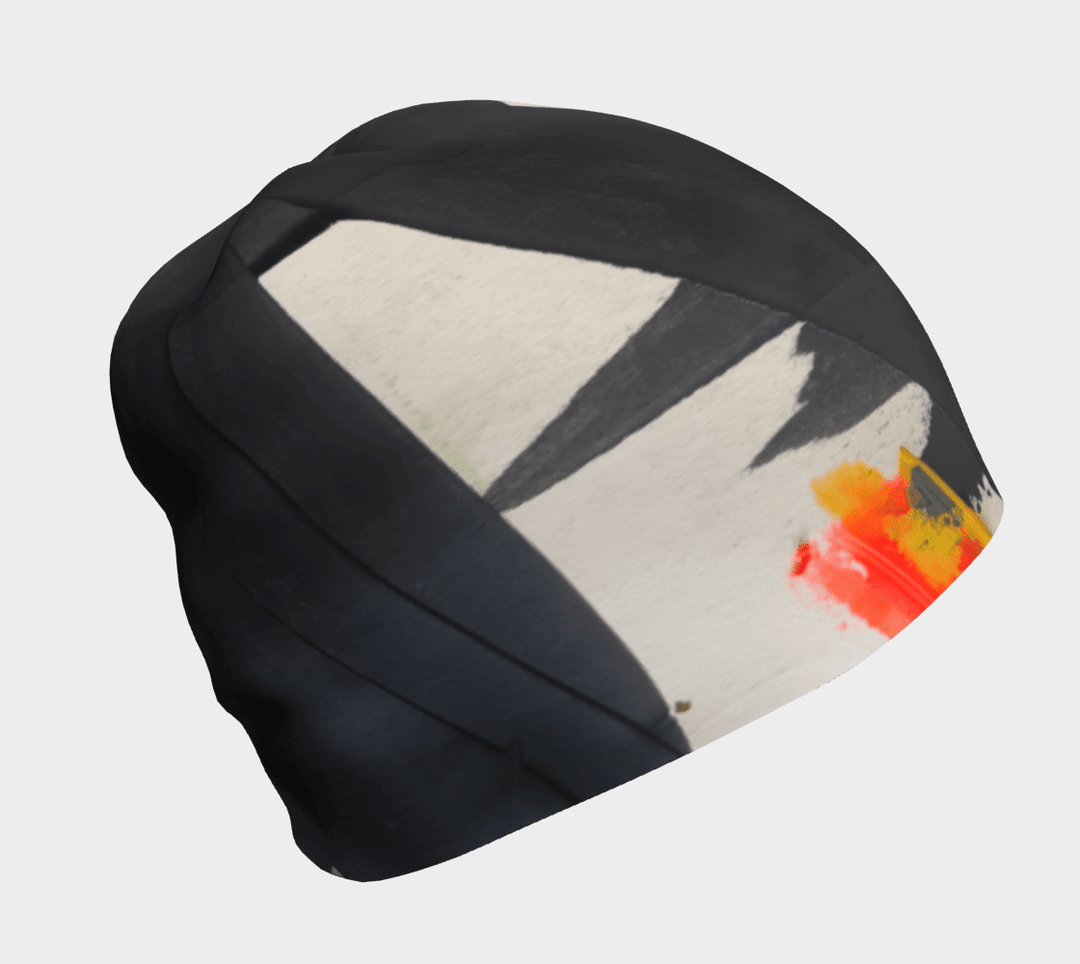 Black and cream abstract art pattern on a black beanie, viewed from the side.