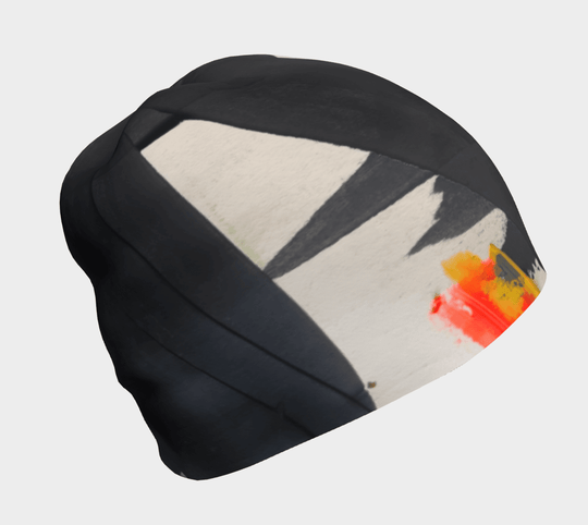 Black and cream abstract art pattern on a black beanie, viewed from the side.