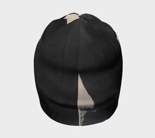 Black and cream abstract art pattern on a black beanie, viewed from the back.