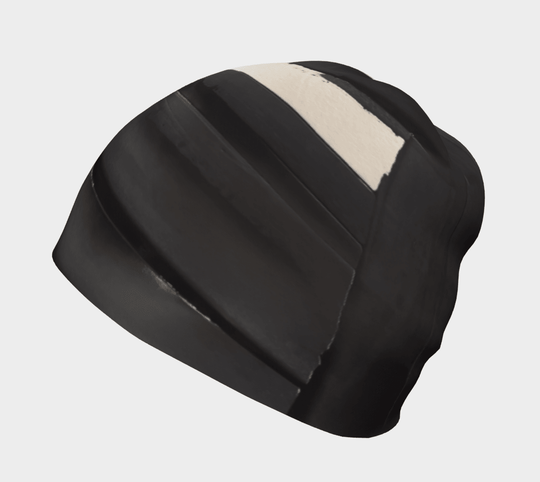Black and cream abstract art pattern on a black beanie, viewed from the side.