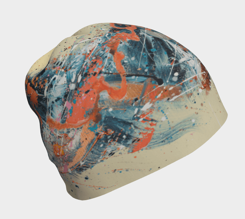 Close-up of the Sphénédon Beanie showcasing abstract teal, orange, and cream paint splatters.