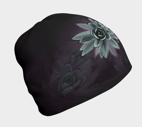 Black beanie with a close-up graphic of a pale green succulent flower against a dark, muted background.