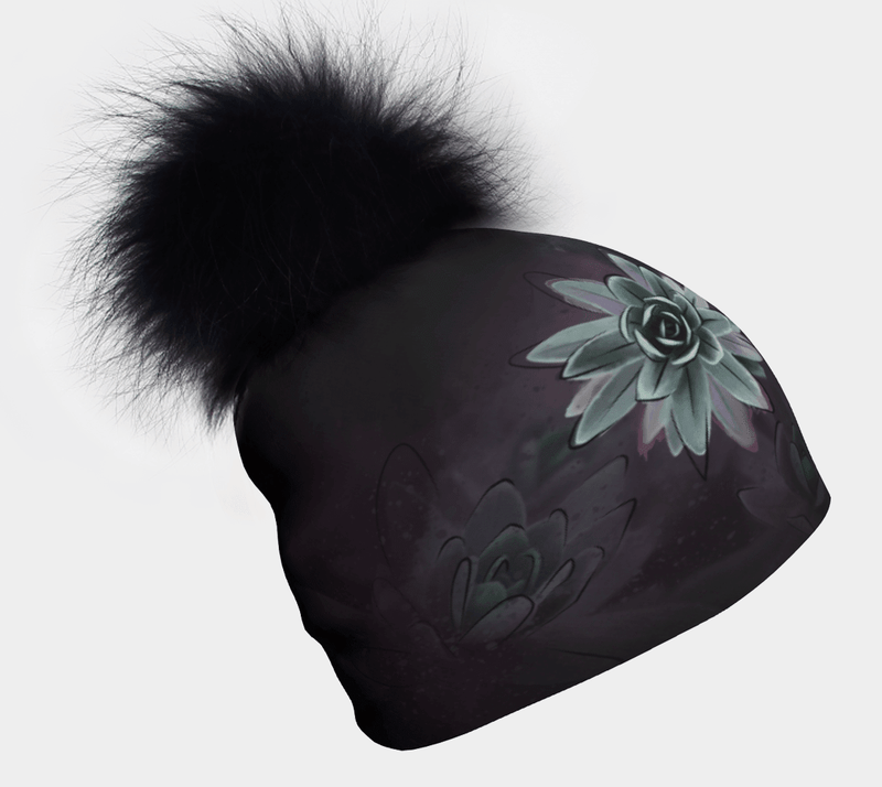 Dark bamboo-lined beanie with teal succulent art print and black removable fur pompom, product flat lay