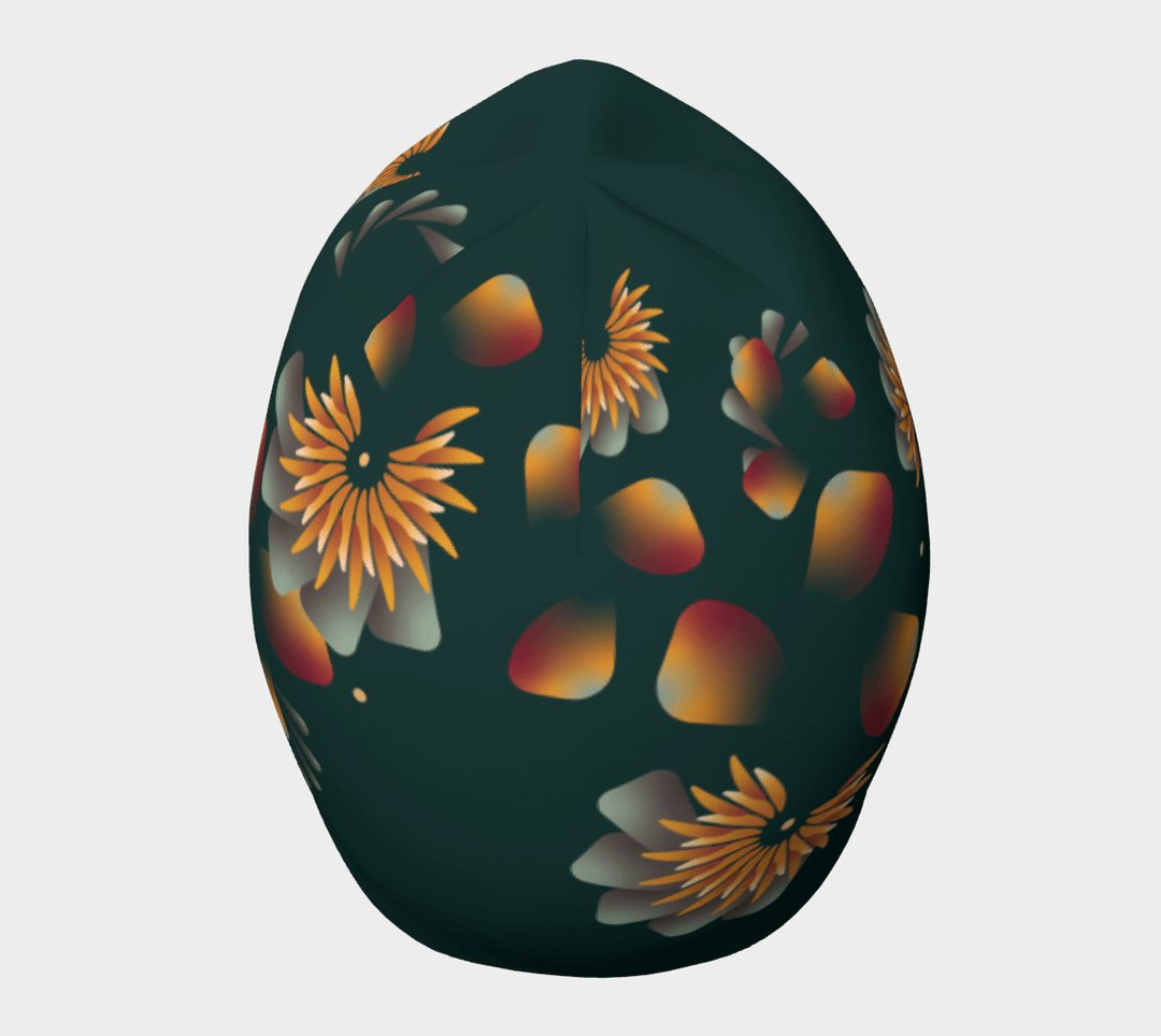 A dark green beanie with a bold, artistic floral pattern in warm sunset hues.