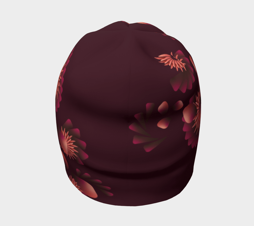 Une tuque marine avec un motif floral dégradé rose et orange, vue de côté.