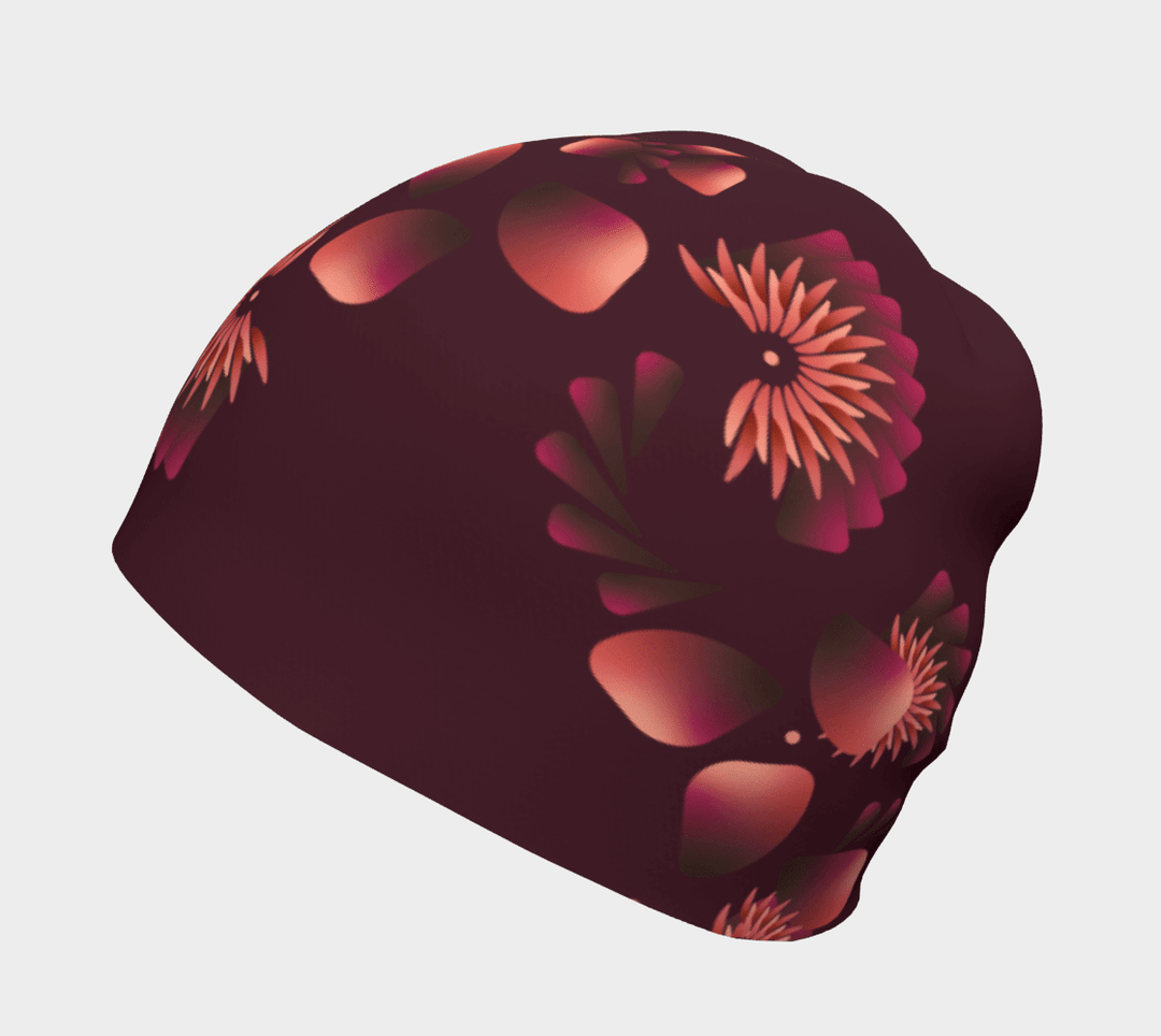 Une tuque marine avec un motif floral dégradé affichée sur un fond uni.