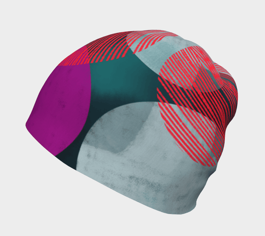 Close-up of the Teal-Dots Beanie showing the abstract dot pattern in teal, gray, red, and purple.