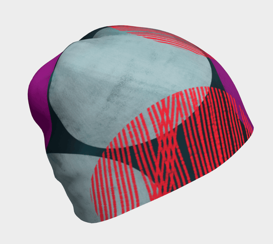 Beanie with teal, gray, red, and purple abstract dot pattern on a white background.