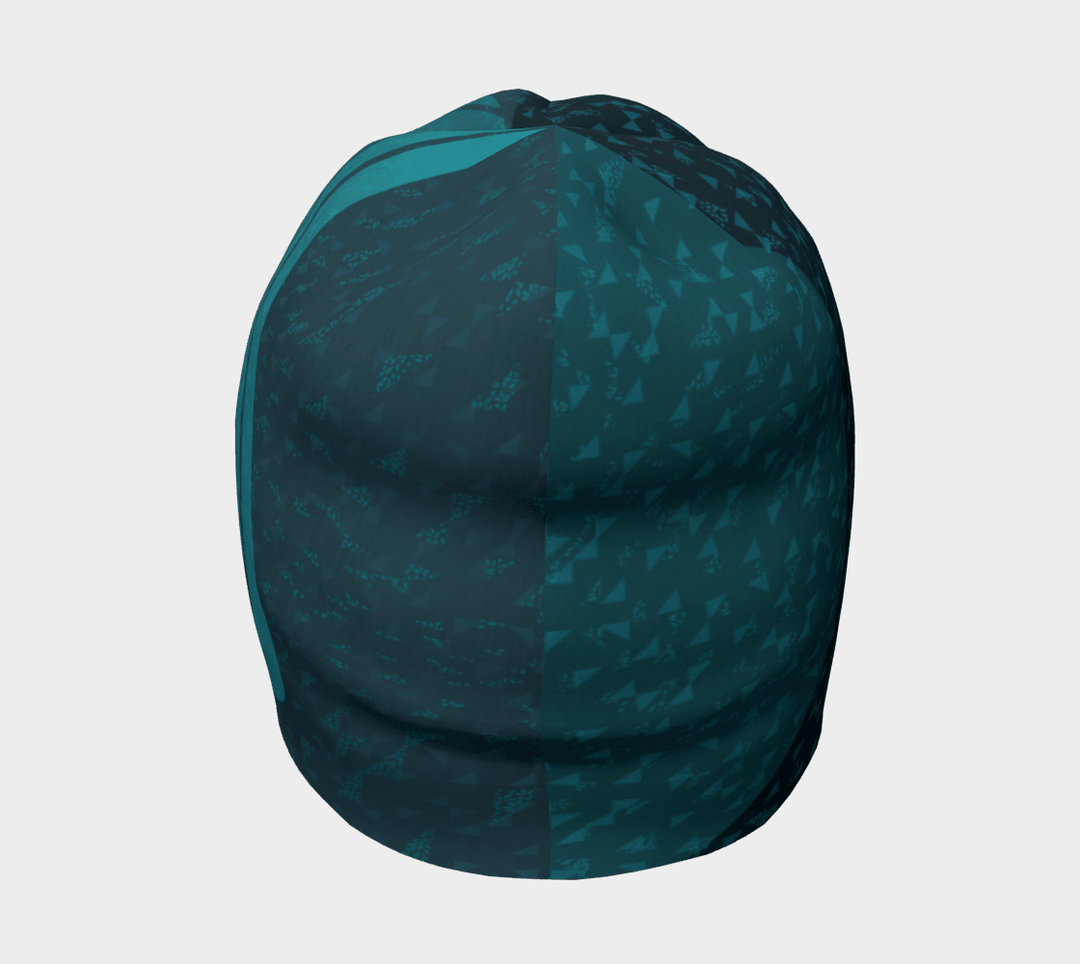 Front view of the Teal Flakes Beanie, displaying a split pattern of triangles and waves in shades of teal.
