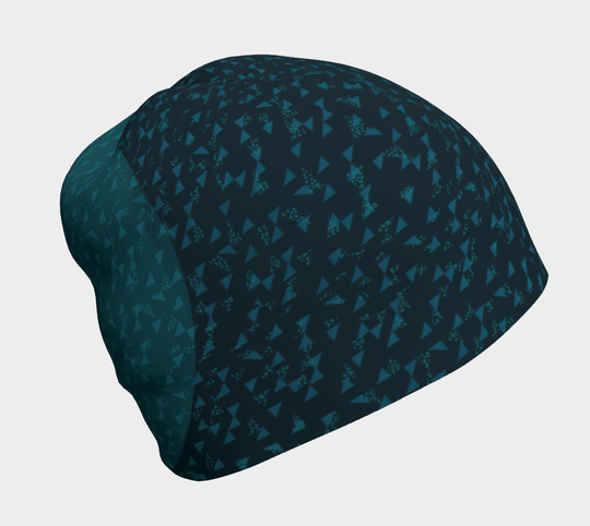 Close-up view of the Teal Flakes Beanie with a dark teal base and scattered light teal triangles.