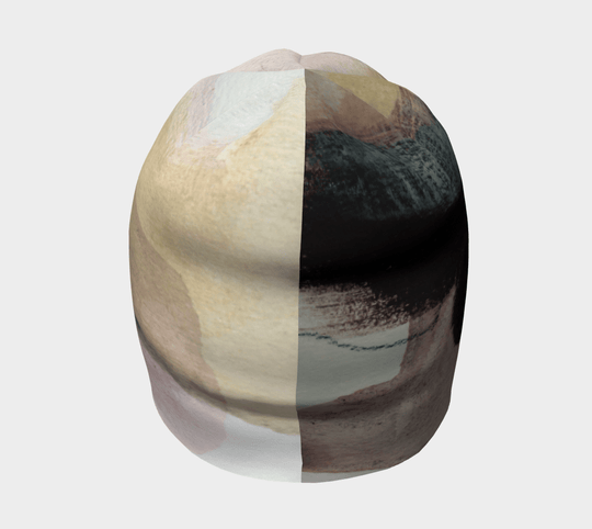 Front view of The Space Between Beanie, split in its pattern to show contrasting abstract elements.