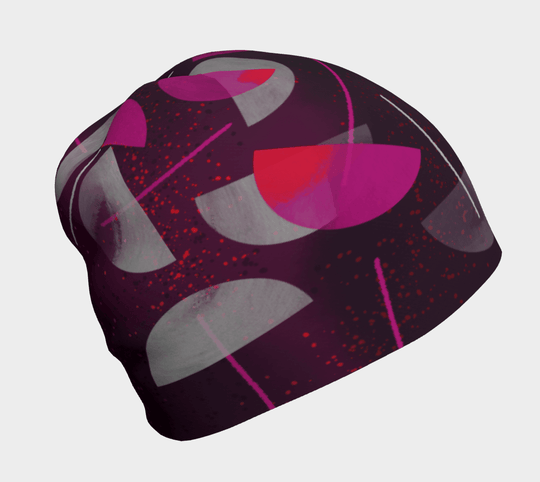 A close-up view of the Umbrella Magenta Beanie, showcasing its abstract magenta, pink, and gray pattern.