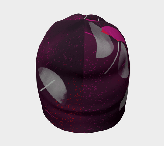 A full view of the Umbrella Magenta Beanie from the front, displaying the intricate artistic pattern.
