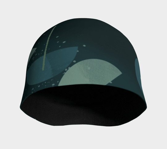 Front view of the inside of the teal abstract pattern beanie, showing the black bamboo lining.