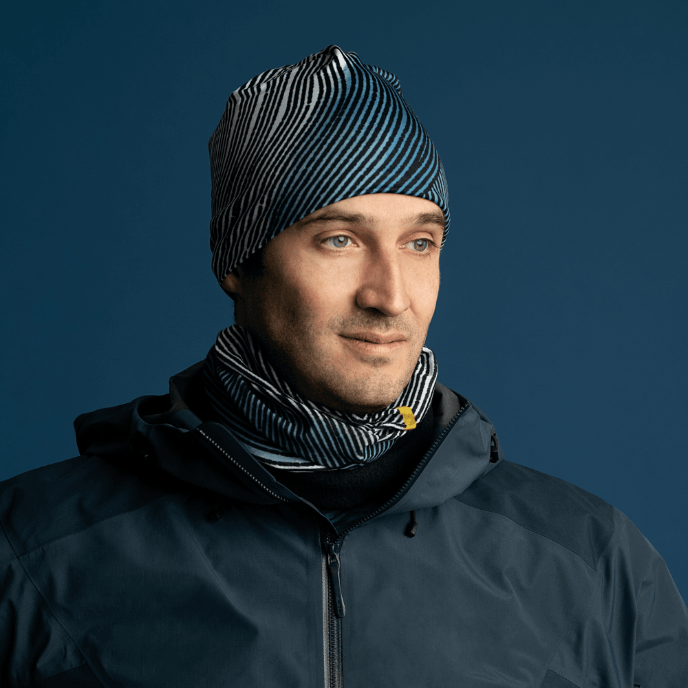 Man wearing the Abstract Lines Beanie and matching neck tube, layered under a dark jacket.