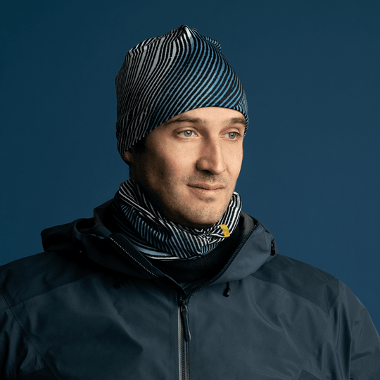 Man wearing the Abstract Lines Beanie and matching neck tube, layered under a dark jacket.