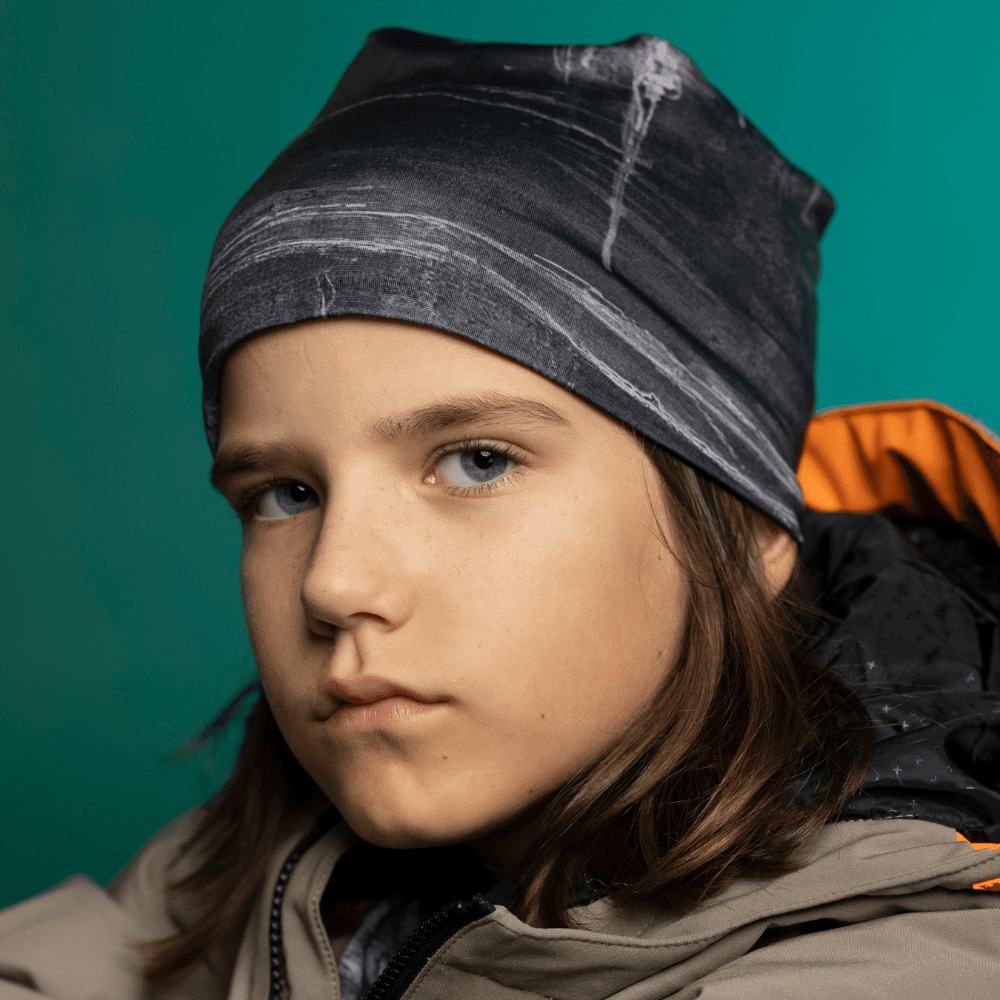Child in Wall Black Beanie looking directly at camera — front-facing close-up showing the fine bamboo-lined stretch fit