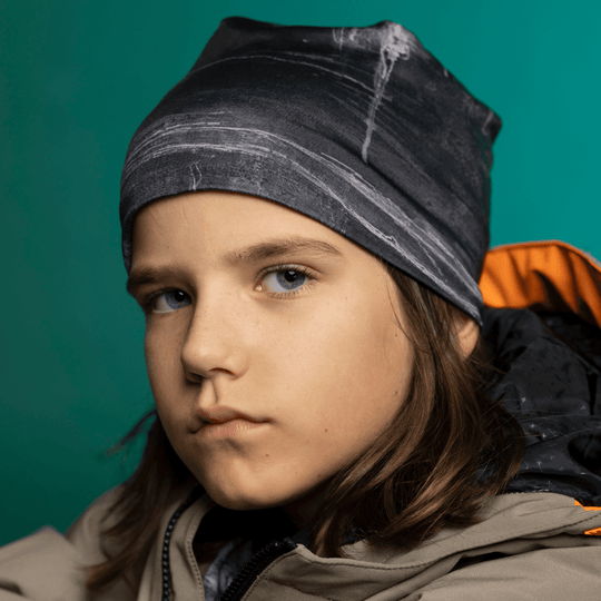Child in Wall Black Beanie looking directly at camera — front-facing close-up showing the fine bamboo-lined stretch fit