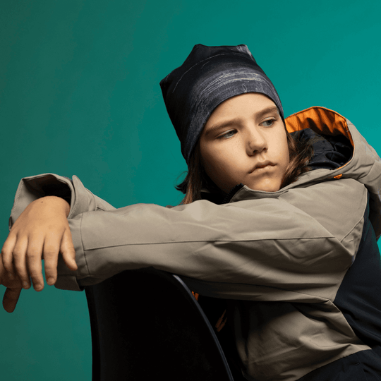 Child wearing the Wall Black Beanie looking downward, showcasing the dark artistic print and relaxed slouchy fit