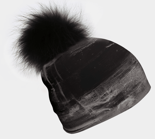 Black beanie with a large fluffy black pom-pom, angled view