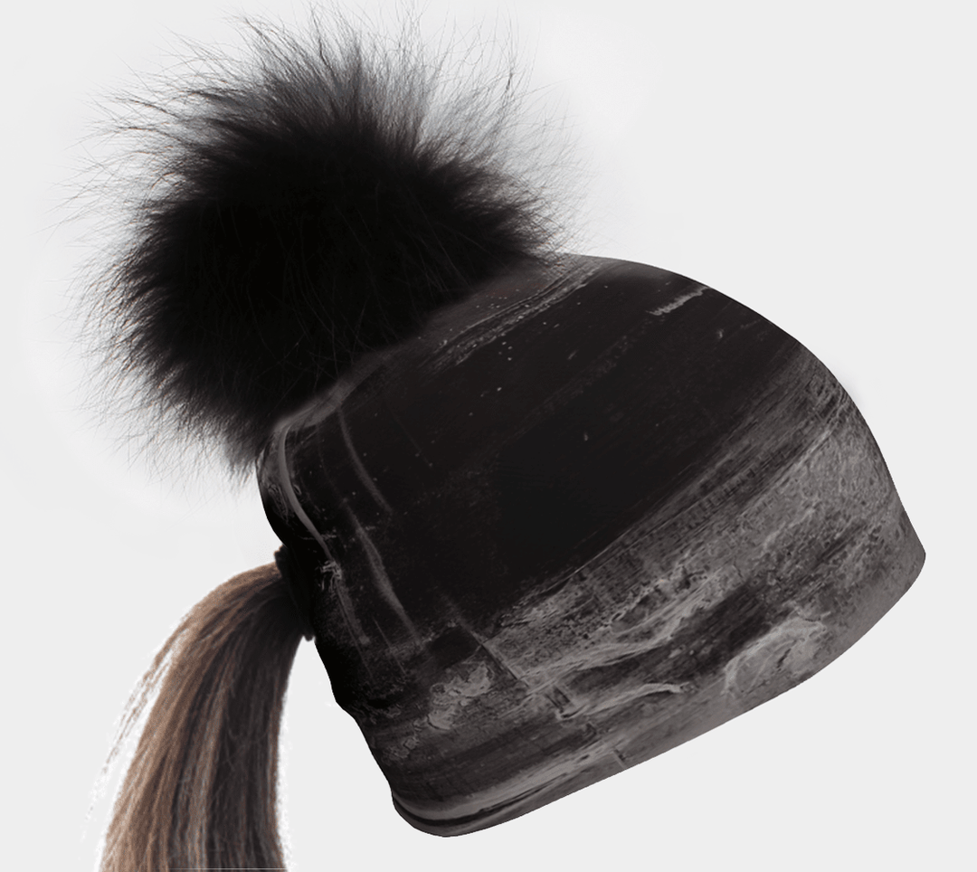 Black Wall ponytail beanie with a fluffy black pompom and hair coming through the back.