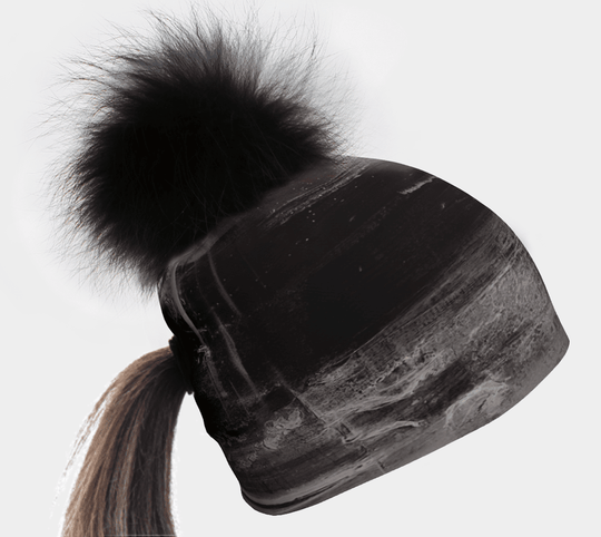 Black Wall ponytail beanie with a fluffy black pompom and hair coming through the back.