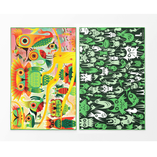 Two sides of the Wall of Birds towel displayed flat, one vibrant and colorful, the other dark with green and white bird illustrations.