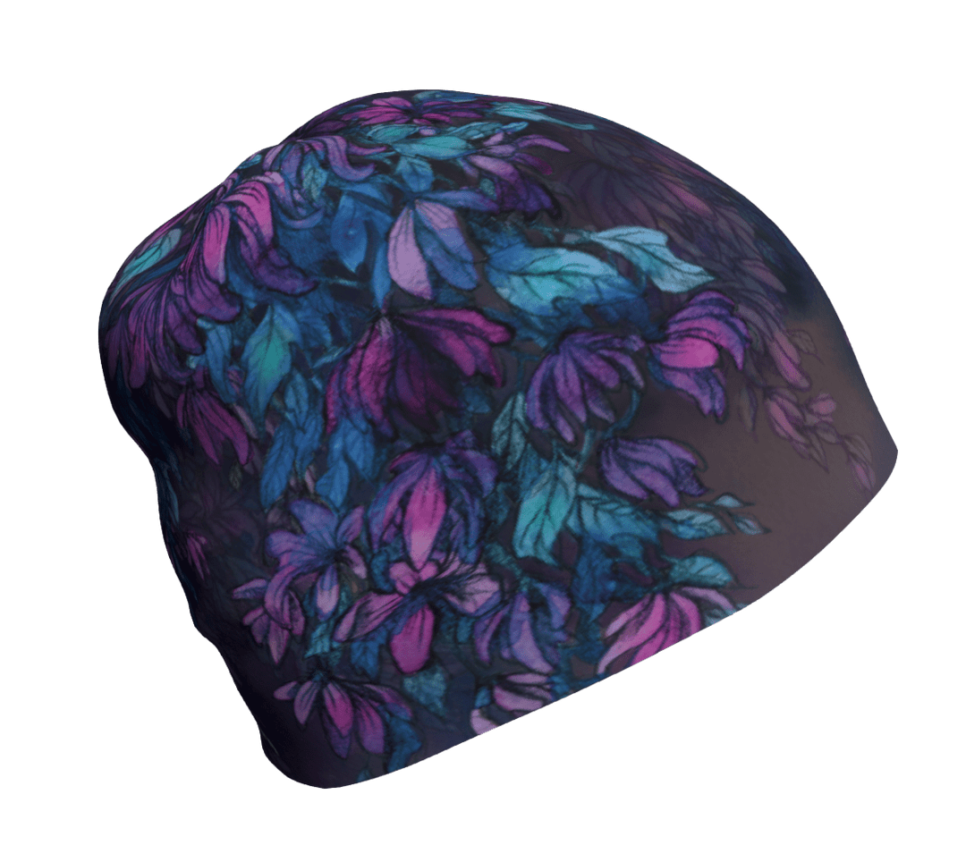 A dark Wisteria beanie with a purple and teal floral pattern laid flat.