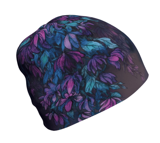 A dark Wisteria beanie with a purple and teal floral pattern laid flat.