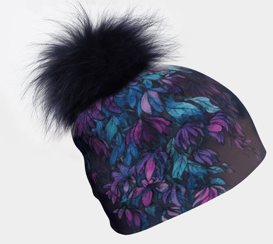 Wisteria Pompom Beanie with a navy pompom and floral print against a white background.