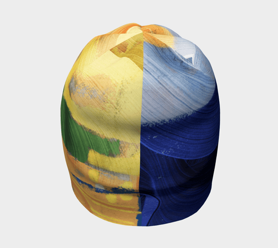 Abstract art beanie with sections of yellow, green, and blue brushstrokes, shown from the side.