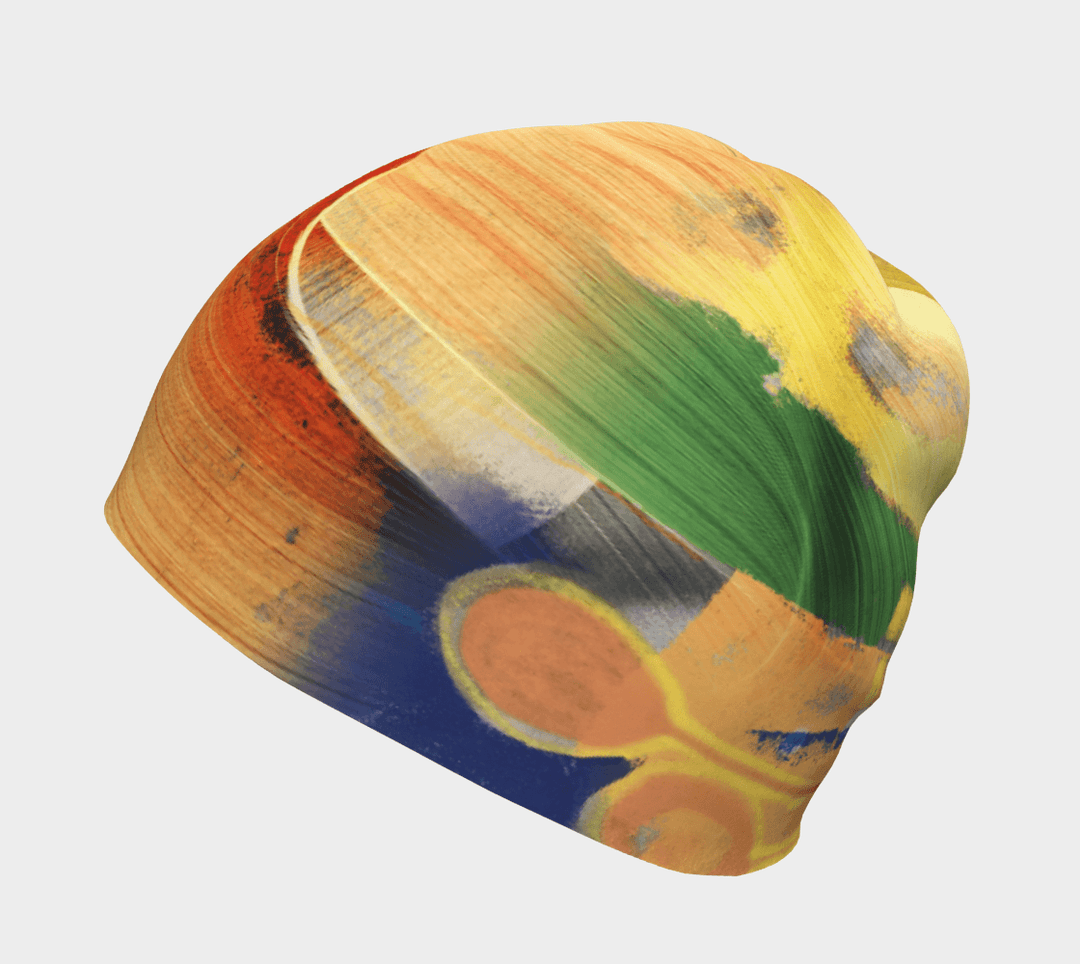Yellow, green, and blue abstract art beanie, shown from the side.