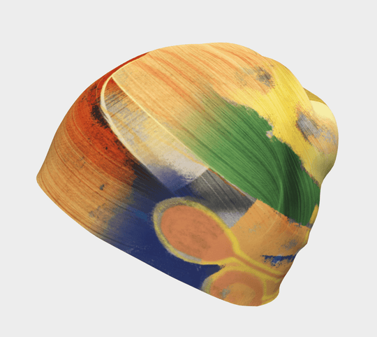 Yellow, green, and blue abstract art beanie, shown from the side.
