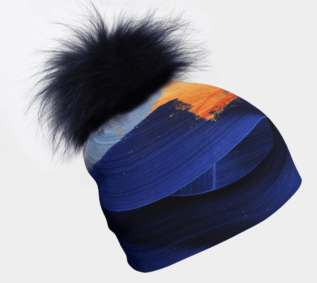 Yellow & Blue Beanie with removable navy fur pom, showcasing abstract brushstroke art.