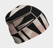 A black beanie with a geometric pattern featuring abstract designs in pink, beige, and white, designed by Valéry Goulet.