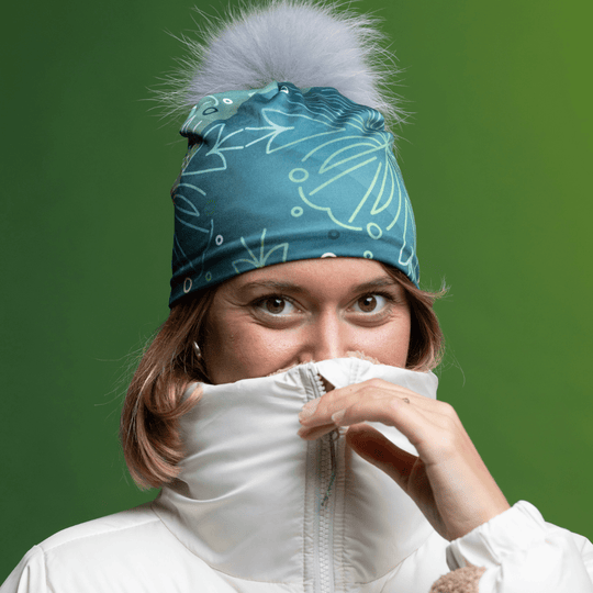 Woman wearing the new Turquoise WallPaper Pompom Beanie by Valery Goulet for the Lalita&