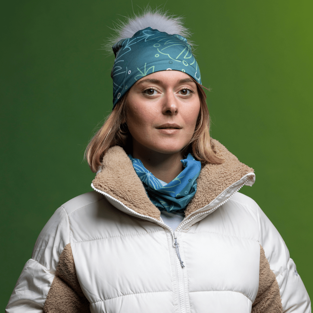 Woman wearing the Turquoise Green Bamboo beanie with Gray Pompom and assorted tube by Valery Goulet for Lalita&