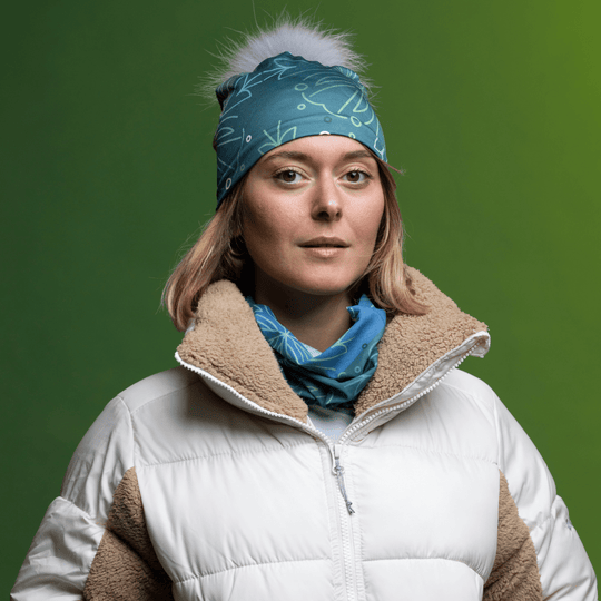 Woman wearing the Turquoise Green Bamboo beanie with Gray Pompom and assorted tube by Valery Goulet for Lalita&
